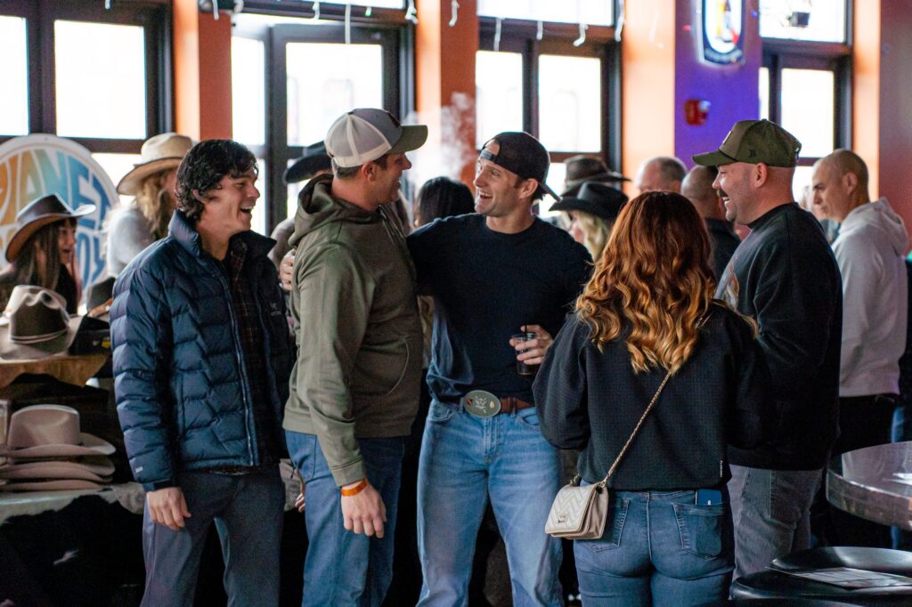 Guests laughing and talking together at Rock the Green Beret